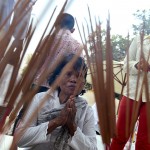 A woman prays at the Choeung Ek memorial as people gather to mark the 41st anniversary of the start of the Khmer Rouge regime