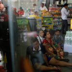 Relatives of Kem Ley, anti-government figure and the head of a grassroots advocacy group, “Khmer for Khmer” sit inside a gas station after he was shot dead in Phnom Penh